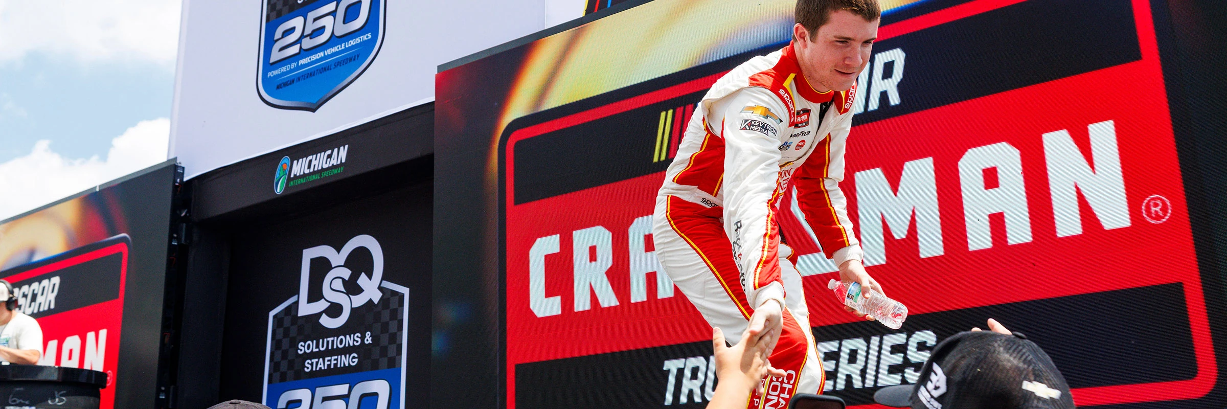 Daniel Dye high-fiving fans on the frontstretch